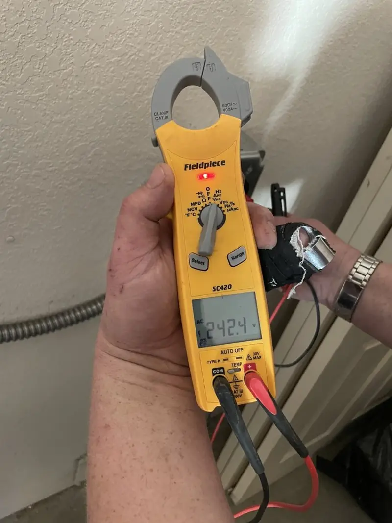 Voltage testing with clamp meter during Whole House Surge Protector in Sixteen Mile Stand